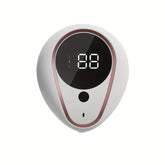 Appareil électronique blanc et or rose distribuant du savon 