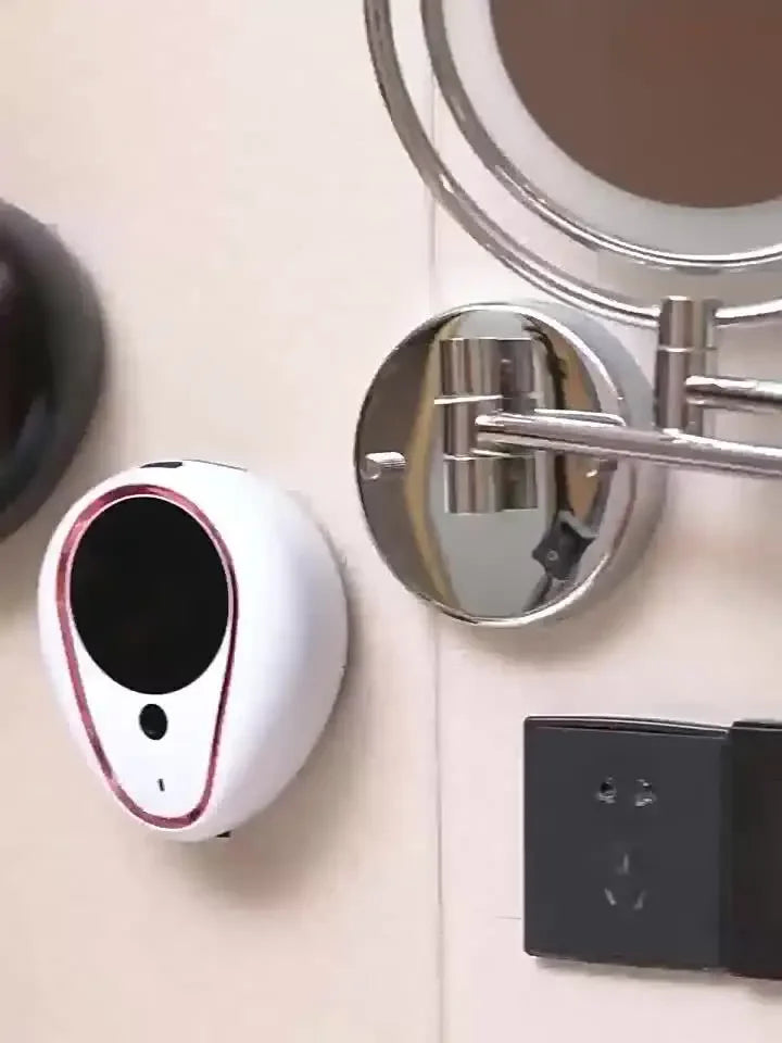 Appareil électronique blanc et or rose distribuant du savon 